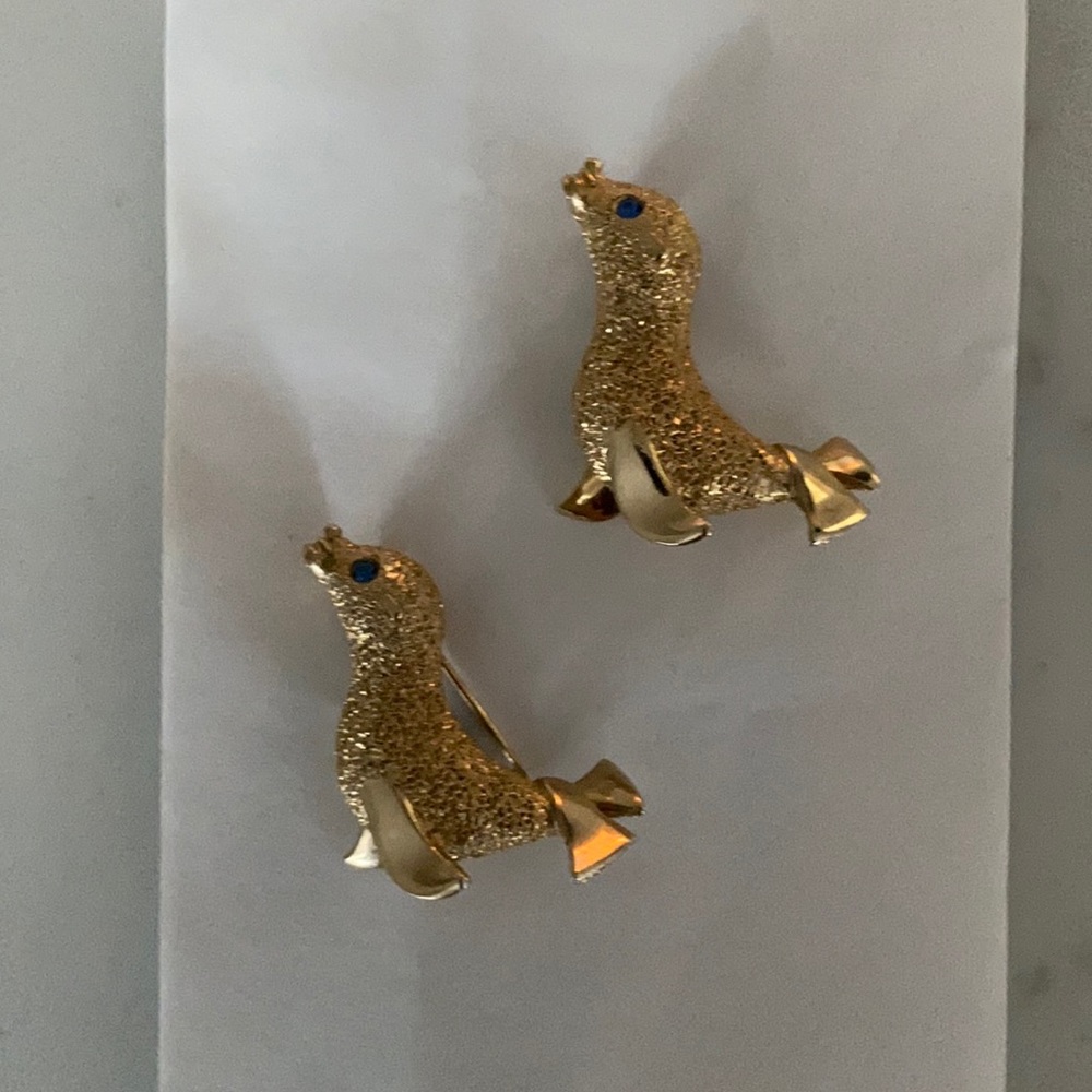 2 seal pins gold is plated (I believe) blue stone eye